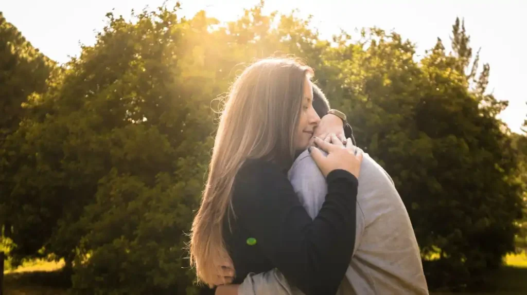 Donna e uomo che si stringono in un abbraccio con luce fioca | Corpo e anima